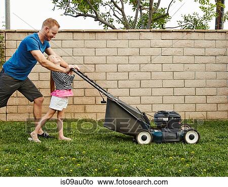 Picture - Father and daughter mowing lawn in backyard. Fotosearch