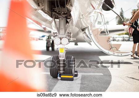 Female businesswoman leaving private jet at airport View Large Photo Image Stock Photo - Female businesswoman leaving private jet at airport. Fotosearch