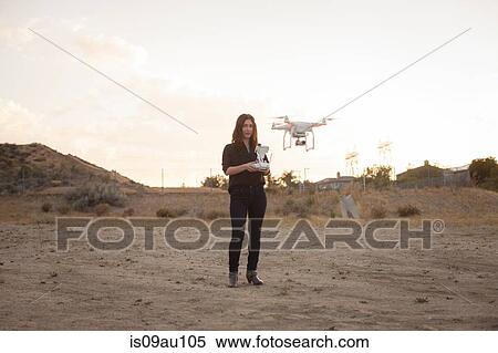 Female commercial operator on scrubland flying drone, Santa Clarita, California, USA View Large Photo Image Stock Photography - Female commercial operator on scrubland flying drone, Santa Clarita, California, USA. Fotosearch
