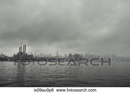Foggy view of waterfront power station and chimney stacks, New York, USA View Large Photo Image Stock Photograph - Foggy view of waterfront power station and chimney stacks, New York, USA. Fotosearch