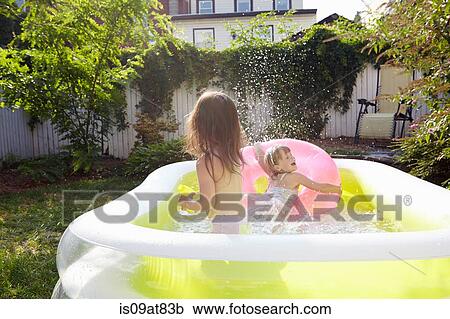 Girls having fun in inflatable pool View Large Photo Image Stock Image - Girls having fun in inflatable pool. Fotosearch