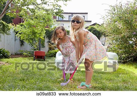 Girls playing kids golf in garden View Large Photo Image Stock Image - Girls playing kids golf in garden. Fotosearch