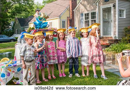 Group of children at kindergarten graduation, wearing paper mortar boards View Large Photo Image Stock Image - Group of children at kindergarten graduation, wearing paper mortar boards. Fotosearch