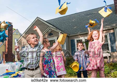 Group of children at kindergarten graduation, throwing paper mortar boards in air View Large Photo Image Stock Image - Group of children at kindergarten graduation, throwing paper mortar boards in air. Fotosearch