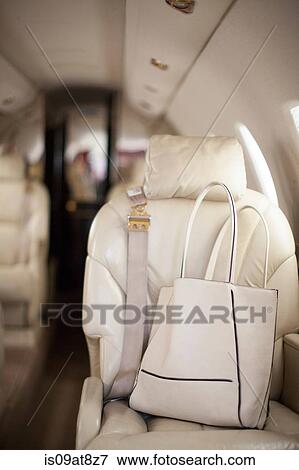 Handbag on seat of luxury private jet View Large Photo Image Stock Photo - Handbag on seat of luxury private jet. Fotosearch