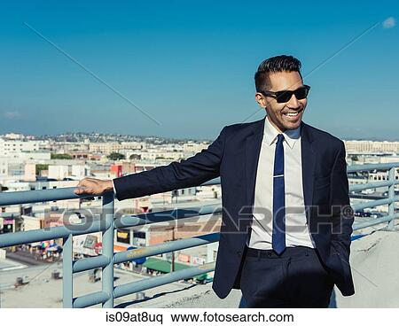 Stock Photography - Happy businessman on roof terrace, Los Angeles, California, USA. Fotosearch