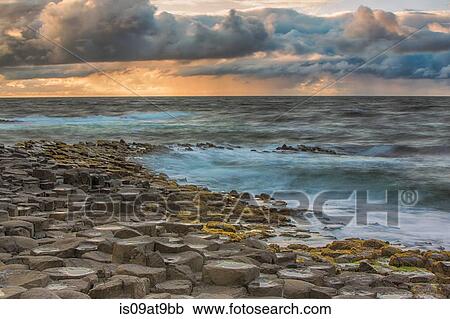 High angle view of Giants Causeway, ocean and dramatic sky, Bushmills, County Antrim, Ireland, UK View Large Photo Image Stock Image - High angle view of Giants Causeway, ocean and dramatic sky, Bushmills, County Antrim, Ireland, UK. Fotosearch