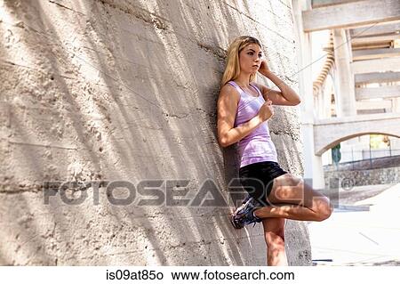 Picture - Jogger leaning against structure, Arroyo Seco Park, Pasadena, California, USA. Fotosearch