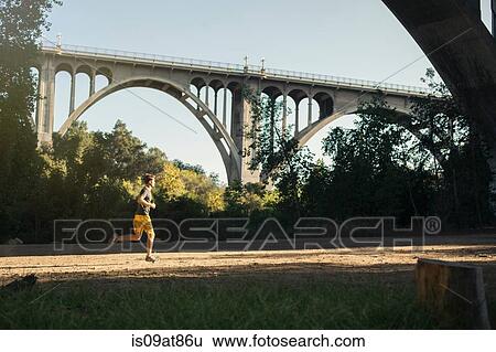 Jogger running, arch bridge in background, Arroyo Seco Park, Pasadena, California, USA View Large Photo Image Stock Photograph - Jogger running, arch bridge in background, Arroyo Seco Park, Pasadena, California, USA. Fotosearch