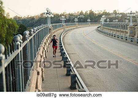 Jogger running on bridge, Arroyo Seco Park, Pasadena, California, USA View Large Photo Image Stock Image - Jogger running on bridge, Arroyo Seco Park, Pasadena, California, USA. Fotosearch