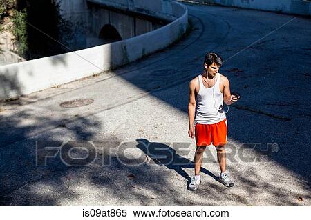 Jogger selecting music on smartphone, Arroyo Seco Park, Pasadena, California, USA View Large Photo Image Stock Photography - Jogger selecting music on smartphone, Arroyo Seco Park, Pasadena, California, USA. Fotosearch
