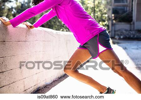 Stock Image - Jogger stretching, Arroyo Seco Park, Pasadena, California, USA. Fotosearch