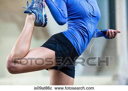 Stock Image - Jogger stretching. Fotosearch