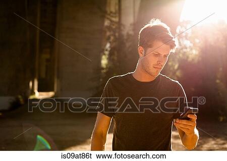 Jogger using phone under arch bridge, Arroyo Seco Park, Pasadena, California, USA View Large Photo Image Stock Photograph - Jogger using phone under arch bridge, Arroyo Seco Park, Pasadena, California, USA. Fotosearch