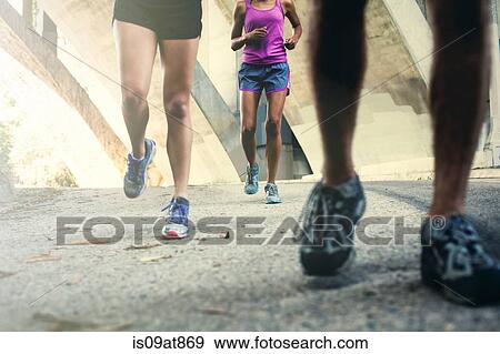 Joggers running on bridge View Large Photo Image Stock Photo - Joggers running on bridge. Fotosearch