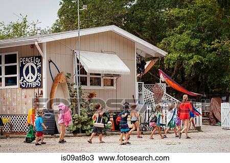 Stock Image - Large group of children and teacher returning to sea school, Sanibel Island, Pine Island Sound, Florida, USA. Fotosearch