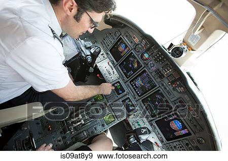 Male pilot preparing cockpit of private jet View Large Photo Image Stock Photo - Male pilot preparing cockpit of private jet. Fotosearch