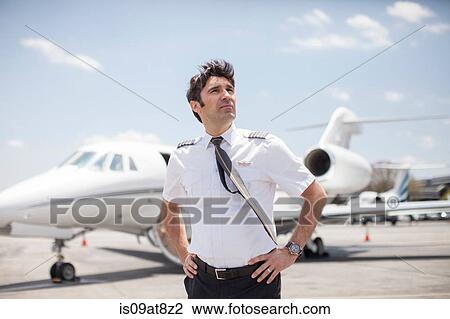 Male private jet pilot looking up at airport View Large Photo Image Stock Image - Male private jet pilot looking up at airport. Fotosearch