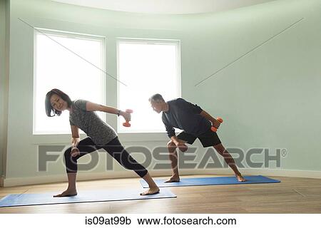 Mature couple on yoga mats exercising using dumbells View Large Photo Image Stock Image - Mature couple on yoga mats exercising using dumbells. Fotosearch