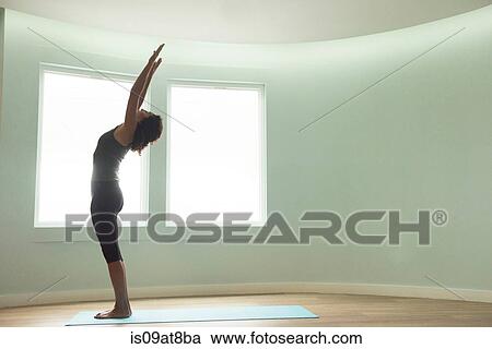 Mature woman doing yoga in curved room View Large Photo Image Stock Image - Mature woman doing yoga in curved room. Fotosearch