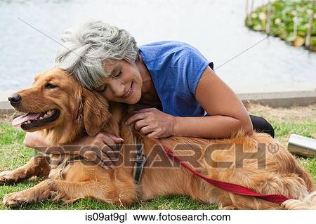 Mature woman hugging dog, outdoors View Large Photo Image Stock Image - Mature woman hugging dog, outdoors. Fotosearch