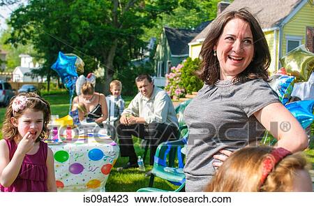 Mid adult woman and young girl at party, outdoors View Large Photo Image Stock Image - Mid adult woman and young girl at party, outdoors. Fotosearch