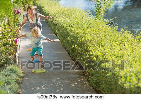 Mother and son playing together, jumping, outdoors View Large Photo Image Stock Photo - Mother and son playing together, jumping, outdoors. Fotosearch
