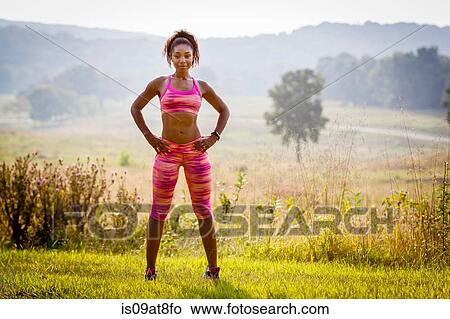 Portrait of confident young female runner in rural park View Large Photo Image Picture - Portrait of confident young female runner in rural park. Fotosearch