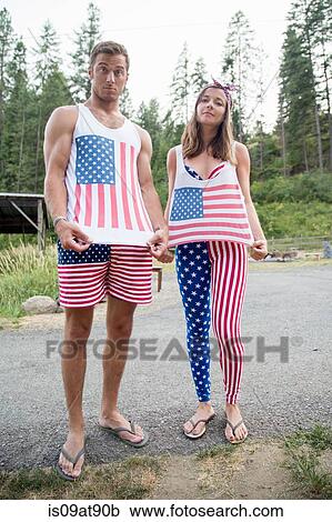 Portrait of couple showing off American flag costume celebrating Independence Day, USA View Large Photo Image Stock Image - Portrait of couple showing off American flag costume celebrating Independence Day, USA. Fotosearch