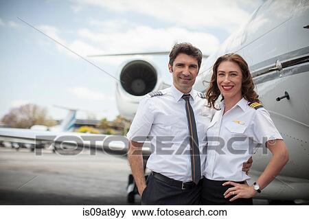 Portrait of male and female private jet pilots at airport View Large Photo Image Stock Photo - Portrait of male and female private jet pilots at airport. Fotosearch