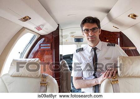 Portrait of male pilot in cabin of private jet View Large Photo Image Stock Photography - Portrait of male pilot in cabin of private jet. Fotosearch