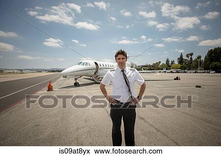 Portrait of male private jet pilot at airport View Large Photo Image Stock Photo - Portrait of male private jet pilot at airport. Fotosearch
