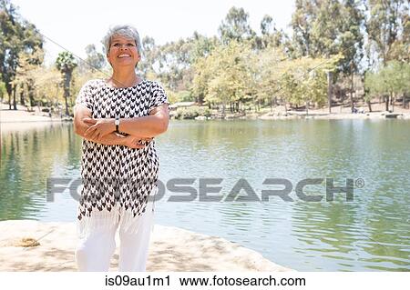 Portrait of mature woman beside lake View Large Photo Image Stock Image - Portrait of mature woman beside lake. Fotosearch
