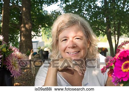 Portrait of senior female farmer with cut flowers View Large Photo Image Stock Image - Portrait of senior female farmer with cut flowers. Fotosearch