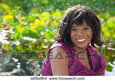 Portrait of senior woman, smiling, outdoors View Large Photo Image Picture - Portrait of senior woman, smiling, outdoors. Fotosearch