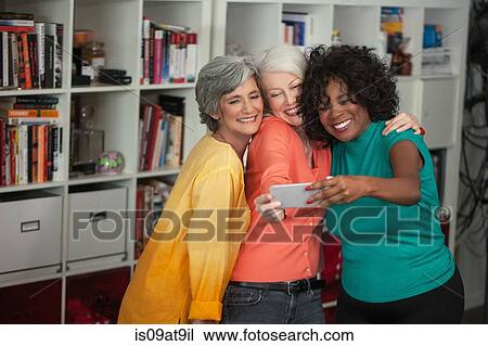 Portrait of three mature women, taking self portrait, using smartphone View Large Photo Image Stock Image - Portrait of three mature women, taking self portrait, using smartphone. Fotosearch