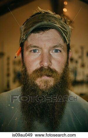 Stock Photo - Portrait of wood artist in workshop. Fotosearch