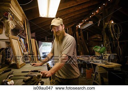Portrait of wood artist working in workshop View Large Photo Image Stock Photo - Portrait of wood artist working in workshop. Fotosearch