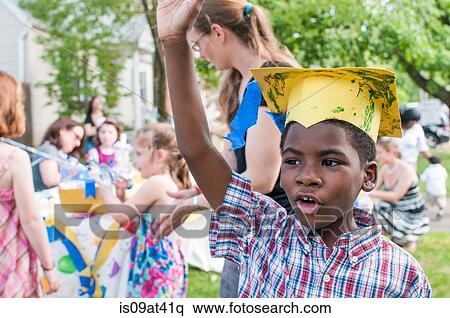 Portrait of young boy at kindergarten graduation, wearing paper mortar board View Large Photo Image Stock Photography - Portrait of young boy at kindergarten graduation, wearing paper mortar board. Fotosearch
