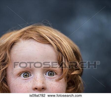 Stock Image - Portrait of young boy, red hair, close-up. Fotosearch