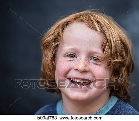 Stock Image - Portrait of young boy, red hair, close-up. Fotosearch