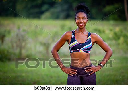 Portrait of young female runner with hands on hips in park View Large Photo Image Stock Image - Portrait of young female runner with hands on hips in park. Fotosearch
