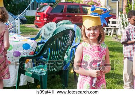 Portrait of young girl at kindergarten graduation, wearing paper mortar board View Large Photo Image Stock Image - Portrait of young girl at kindergarten graduation, wearing paper mortar board. Fotosearch