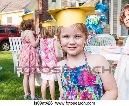 Portrait of young girl at kindergarten graduation, wearing paper mortar board View Large Photo Image Stock Photograph - Portrait of young girl at kindergarten graduation, wearing paper mortar board. Fotosearch