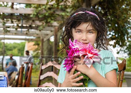 Portrait of young girl holding flowers, outdoors View Large Photo Image Stock Image - Portrait of young girl holding flowers, outdoors. Fotosearch