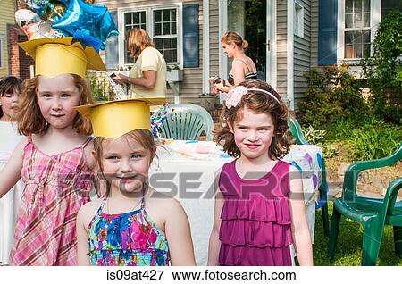 Portrait of young girls at kindergarten graduation, wearing paper mortar boards View Large Photo Image Stock Photo - Portrait of young girls at kindergarten graduation, wearing paper mortar boards. Fotosearch