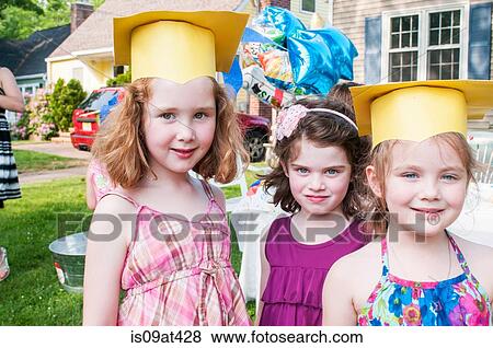 Portrait of young girls at kindergarten graduation, wearing paper mortar boards View Large Photo Image Stock Photo - Portrait of young girls at kindergarten graduation, wearing paper mortar boards. Fotosearch