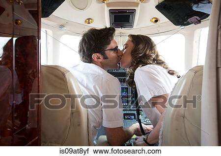 Rear view of male and female pilots kissing in cockpit of private jet View Large Photo Image Stock Image - Rear view of male and female pilots kissing in cockpit of private jet. Fotosearch