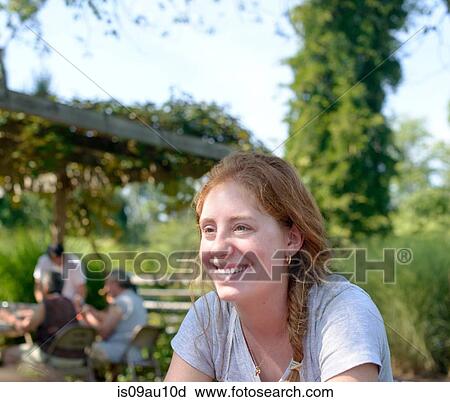 Red haired young woman outdoors looking away smiling View Large Photo Image Stock Image - Red haired young woman outdoors looking away smiling. Fotosearch