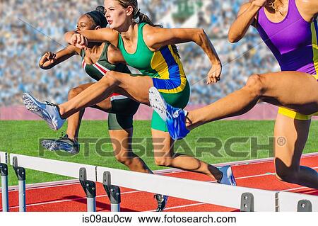 Runners jumping over hurdle on track View Large Photo Image Stock Photo - Runners jumping over hurdle on track. Fotosearch